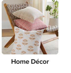 An image of a chair with a variety of throw pillows. Home decor. 