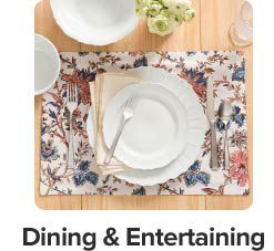 An image of plates and silverware on a decorative placemat. Dining and entertaining.