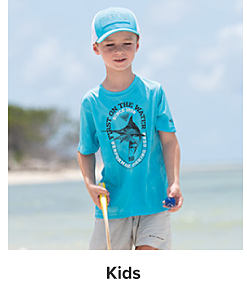 Young boy wearing a blue shirt and matching hat. Kids. 