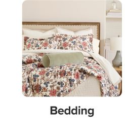 Floral bedding with green pillow. Shop bedding.