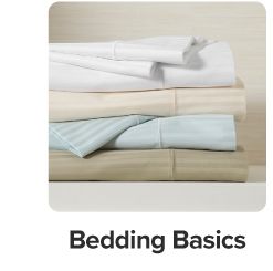 A stack of sheets and pillow cases. Shop bedding Basics