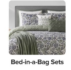 Black floral bedding with green accent pillows and blankets. Shop bed in a bag sets.
