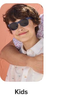 A boy in a button down and sunglasses. Kids.