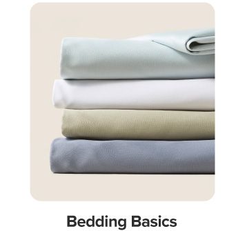 A stack of folded sheets. Shop bedding basics.