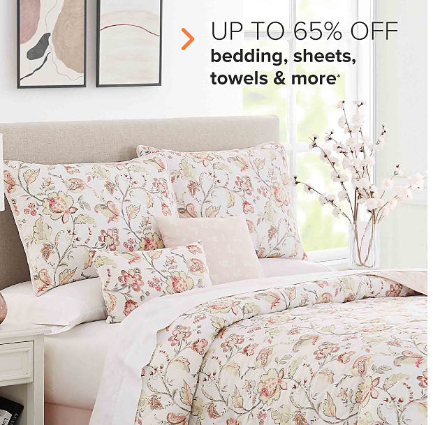 A white bedding set with a beige and pink floral pattern. Up to 65% off bedding, sheets, towels and more. 