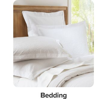 An image of a bed with white bedding. Shop bedding.