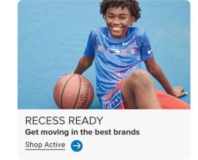 A boy in a blue tee and orange shorts with a basketball. Recess ready. Get moving in the best brands. Shop active.