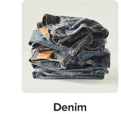 A stack of folded denim. Shop denim.