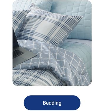 An image of a bed with plaid bedding. Shop bedding.