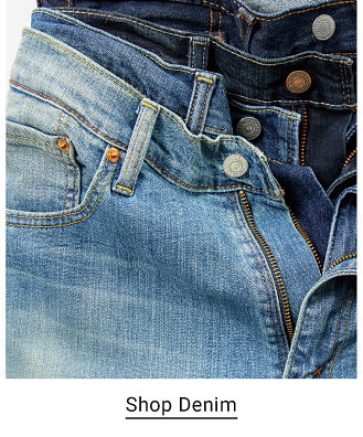 A close up of jeans laid on top of each other, showing the zipper and pocket. Shop denim. 