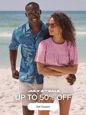 A man and a woman on a beach in summer fashion. July fourth sale. Up to 50% off. Get coupon.