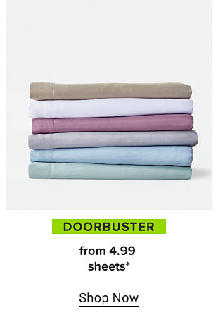 A stack of folded sheets in brown, white, purple, gray, light blue and teal. Doorbuster, from 4.99 sheets. Shop now.