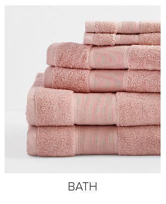 An image of a stack of pink folded towels. Shop bath.