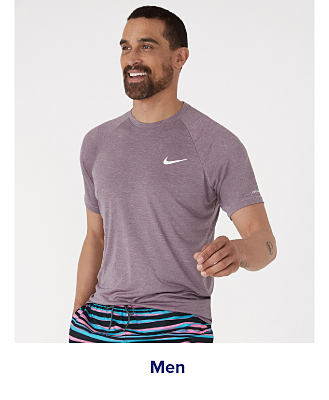 A man in a gray Nike shirt. Shop men. 