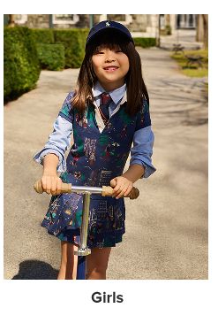 A girl in a Polo dress, hat and accessories. Shop girls. 