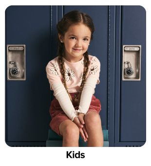 Girl in cream sweater. Shop kids.