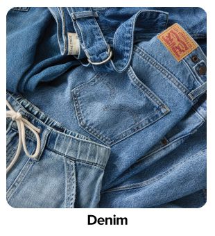 Close-up of denim jacket with metal hardware. Shop denim.