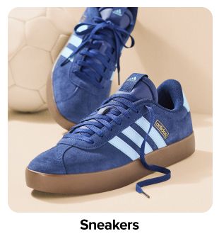Blue sneakers with white stripes. Shop sneakers.