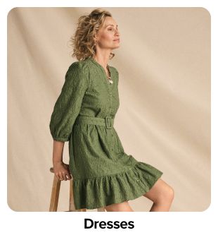 Woman in green long-sleeve dress. Shop dresses.