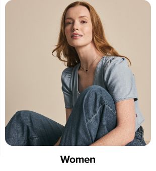 Woman in denim jacket and jeans. Shop women.