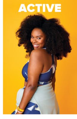 A woman in a blue and white activewear set with a sweatshirt tied at her waist. Active. 