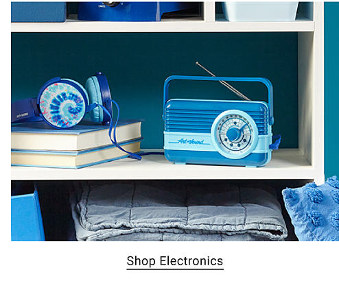 Shop kitchen and dining. A blue radio and headphones with a tie dye pattern. Shop electronics.