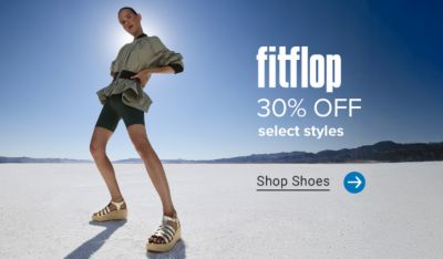A woman in sandals. Fit flop. 30% off select styles. Shop shoes.