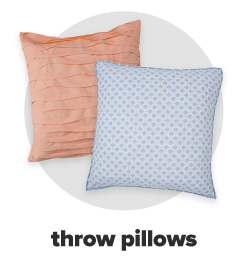 A square, coral throw pillow. A square, light blue throw pillow featuring a lattice print. Throw pillows.