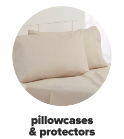 A set of two king pillows in ivory pillowcases. Pillowcases and protectors.
