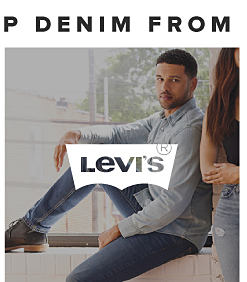 A man in a blue long sleeve button up and Levi's jeans. Levi's. 