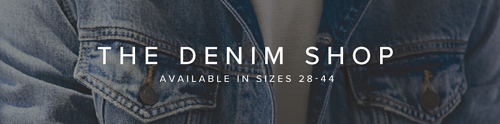 A closeup of a denim jacket with a white tee underneath. The Denim Shop. Available in sizes 28-44. 