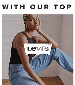 A woman in a black top and blue jeans. Levi's