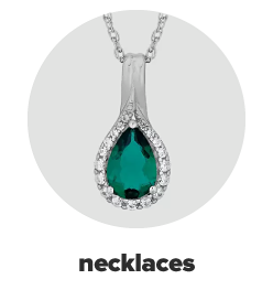 A green gemstone and diamond accent pendant necklace. Shop necklaces.