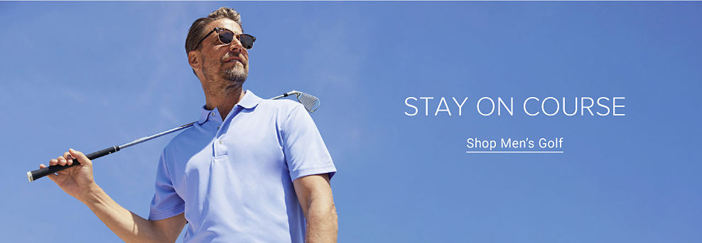 Man wearing a blue polo shirt and holding a golf club. Stay on course. Shop men's golf