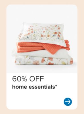 Image of floral bedding and an orange blanket. 60% off home essentials.