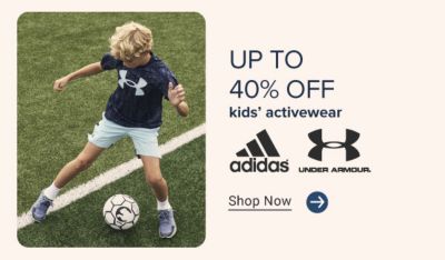 Up to 40% kids' activewear. Adidas and Under Armour. Shop now. A kid in activewear.