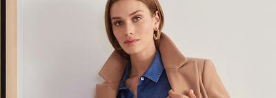 An image of a woman wearing a beige coat.