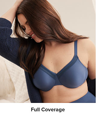 Image of a woman wearing a blue bra. Full coverage.