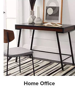 An image of a small wooden desk and chair. Shop home office. 