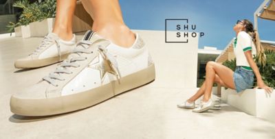 Close up image of white sneakers. Image of a woman in white sneakers. Shu Shop.