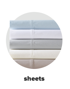 A stack of folded sheets in light blue, white, gray, tan and brown. Sheets.. 