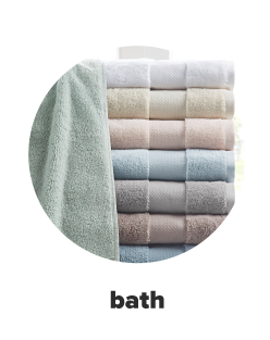 A stack of twoels in white, tan, light pink, light blue, gray, brown and blue. Bath. 