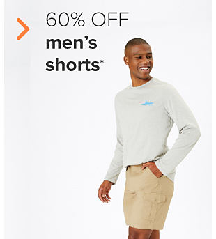 A man in a gray long sleeve t-shirt and khaki shorts. 60% off men's shorts.