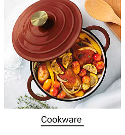 A burgundy Dutch oven with roasted vegetables. Shop cookware.