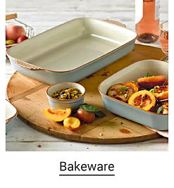 An empty baking dish and another filled with ingredients. Shop bakeware.
