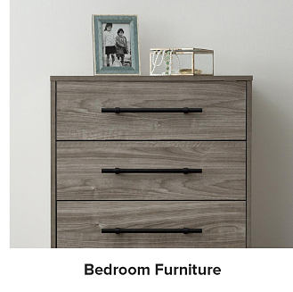 Grey dresser with black drawer pulls. Bedroom furniture.