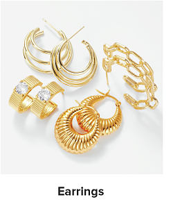 Assortment of gold and silver earrings. Shop fashion jewelry.