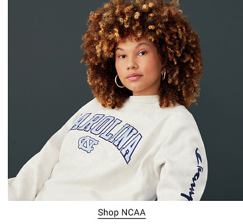 A woman in a University of North Carolina sweatshirt. Shop NCAA. 