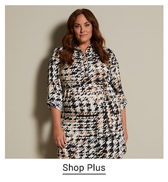 An image of a woman wearing a printed dress. Shop plus
