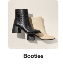 Image of a black and beige heeled boot. Shop booties.